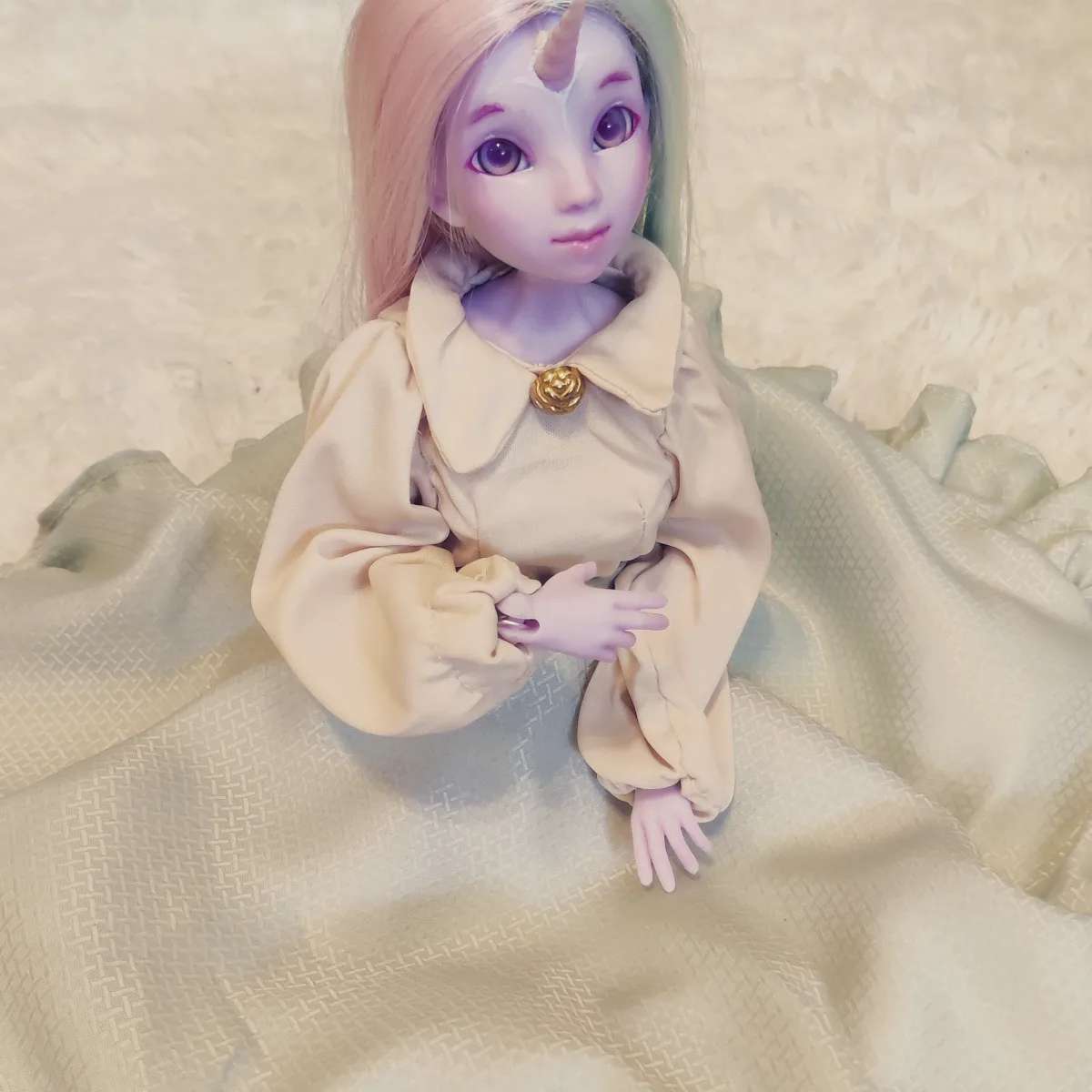 Profile picture of a purple ball jointed doll with a unicorn horn