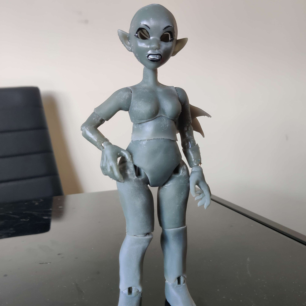 A blank grey doll standing on a table